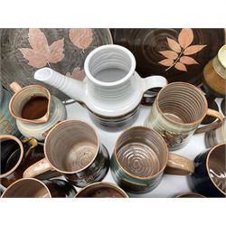Wold studio pottery tankards, in various colours and relief decoration together with other studio items including vases, jugs and pots 