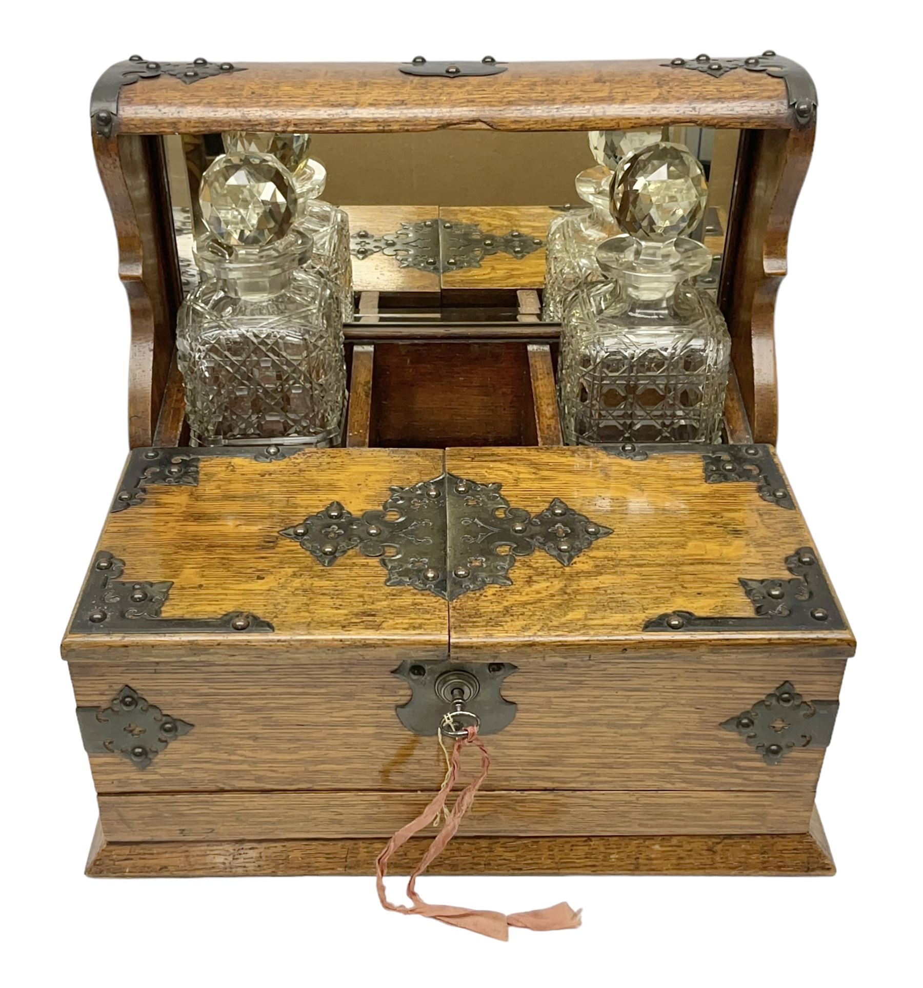 Victorian oak tantalus, mirrored high-back with recess for housing the decanters, behind a hinged box, with cribbage board to the concealed drawer below, marked Barman, London, H33cm, L37cm
