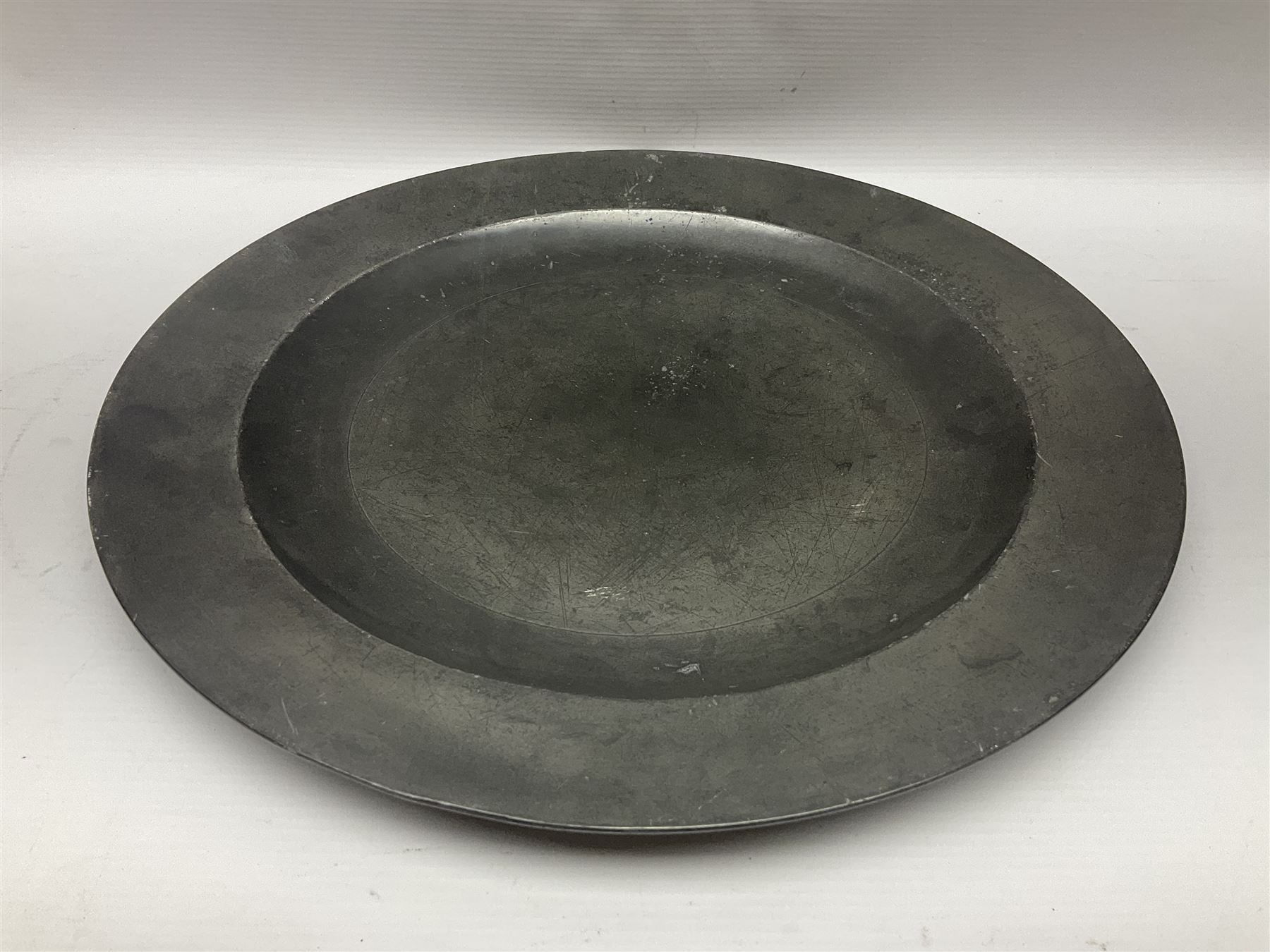 Group of seven 19th century pewter chargers, each of circular form with dished centre, two examples with touch marks verso, each approximately D39cm