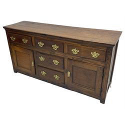 George III country oak dresser base,  rectangular top over with three central drawers flanked by two drawers and two panelled cupboards, each with moulded fronts, on stile feet