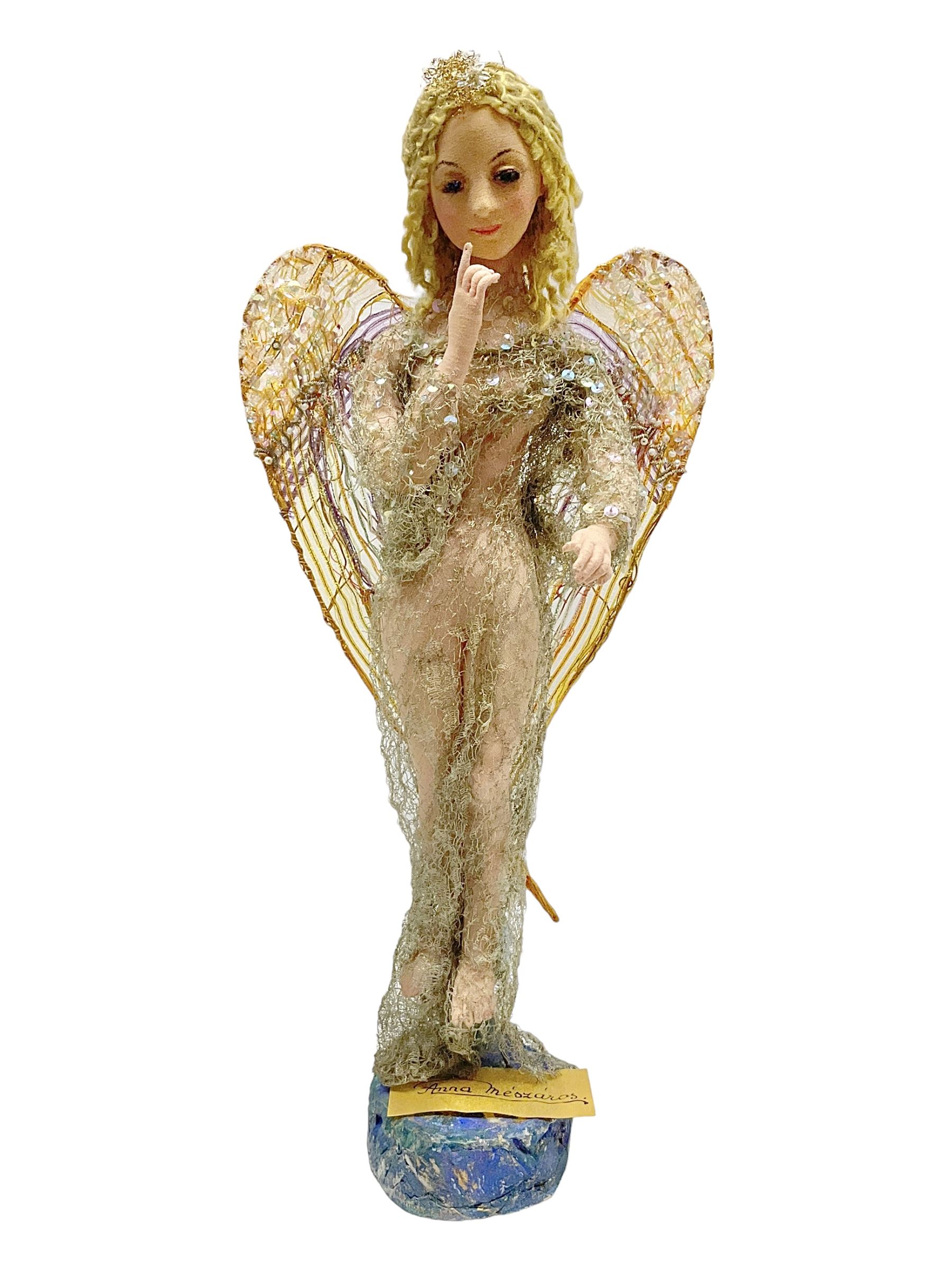Anna Meszaros Hungary - hand made needlework figurine of an Angel with metallic lace full length dress and open threadwork wings; on moulded base H45cm Auctioneer's Note: Anna Meszaros came to England from her native Hungary in 1959 to marry an English businessman she met while demonstrating her art at the 1958 Brussels Exhibition. Shortly before she left for England she was awarded the title of Folk Artist Master by the Hungarian Government. Anna was a gifted painter of mainly portraits and sculptress before starting to make her figurines which are completely hand made and unique, each with a character and expression of its own. The hands, feet and face are sculptured by layering the material and pulling the features into place with needle and thread. She died in Hull in 1998.
