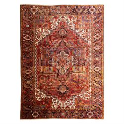 North West Persian Heriz hand-knotted carpet, madder red ground, with a large central geom...