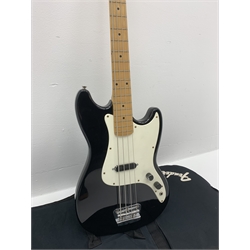  Fender Squier Bronco Affinity Series electric bass guitar, in black and white, serial no. IC021107489, L108cm, in associated Squier soft carrying case. From the collection of the late John Burgess of Beverley who played in the bands Penjants, Wine, Strollers, Revox, Sound Foundation, Pickle Belly Alley, Ragamuffins and Jerryattricks.