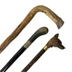 19th century painted bamboo walking cane, the handle carved as a fox with glass eyes, with gilt metal stamped LB, together with an ebonised wooden walking stick, with horn pommel and hallmarked silver collar and a curved wooden walking stick, with monogrammed white metal cap, tallest L90cm