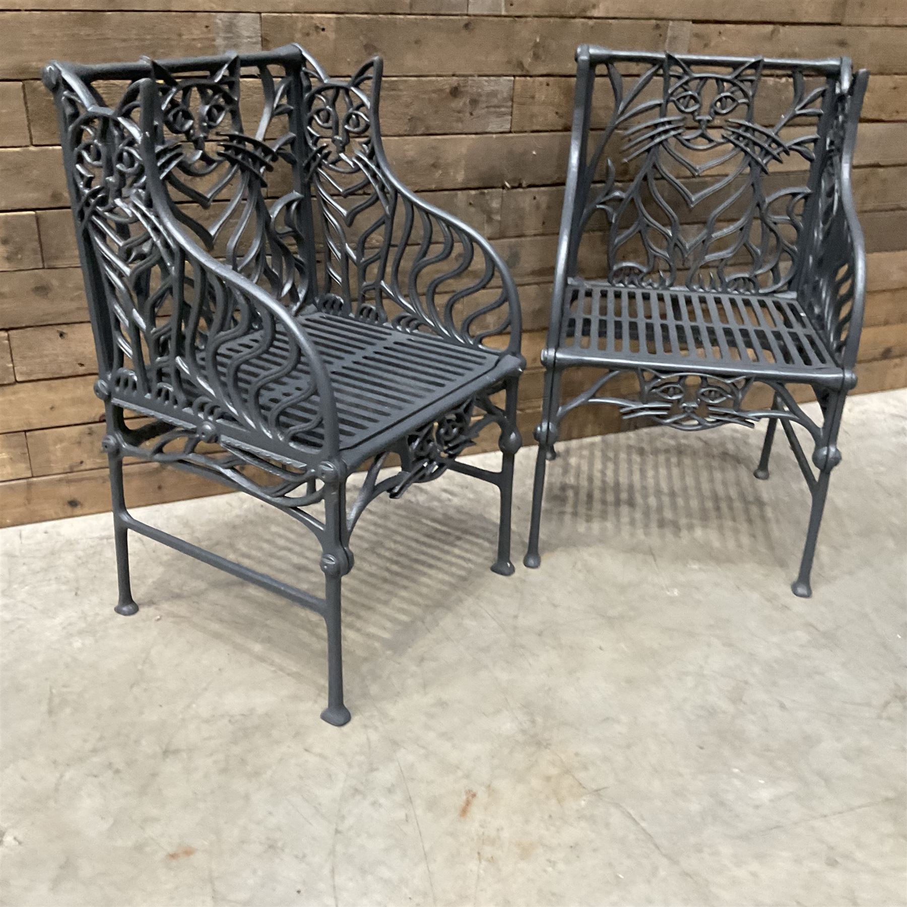 Richard Bawden (1936-2024): Pair of Cat design painted cast iron garden armchairs