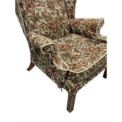 Parker Knoll - mid-20th century wingback armchair, upholstered in tapestry style floral fabric, raised on square moulded supports 