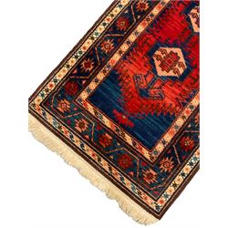 Persian Hamadan red and blue ground rug, the field with geometric pole medallion, guarded border with trailing band and repeating geometric motifs (160cm x 86cm); and a sand ground rug decorated with floral Herati motifs (180cm x 89cm)