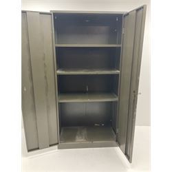 Metal storage cabinet, two doors enclosing three shelves 