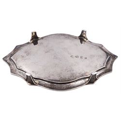 George III silver teapot stand, of shaped form with engraved foliate border and central initial, upon four bracket feet, hallmarked John Langlands I & John Robertson, Newcastle, no date letter present, W18.5cm, approximate weight 4.65 ozt (144.7 grams)