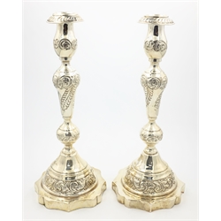  Pair of silver Sabbath candlesticks with leaf and scroll decoration on on scalloped weighted bases by Moshe Rubin London 1926, H.26.5cm   