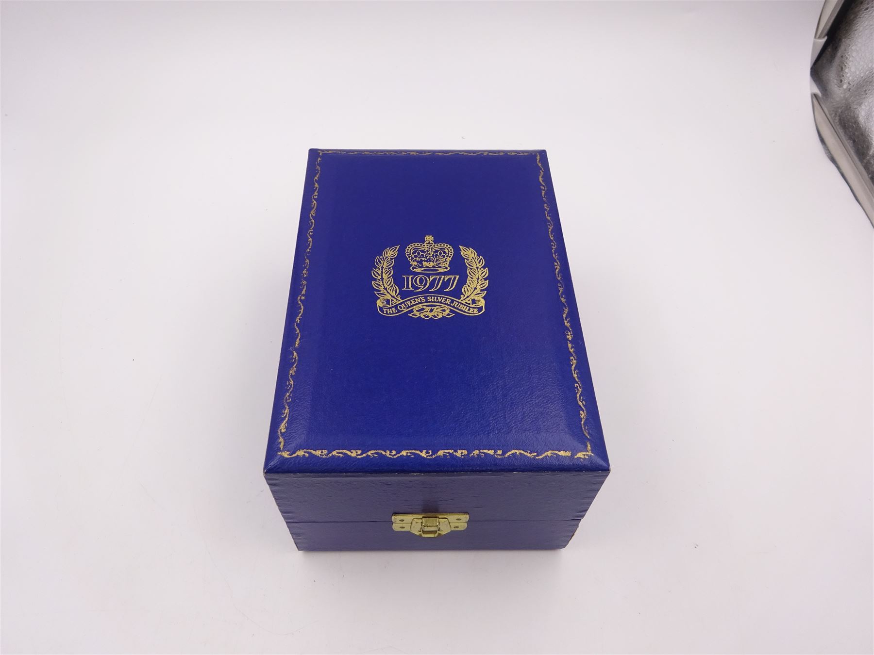 Modern limited edition silver goblet, commemorating Queen Elizabeth II silver jubilee, of plain form with gilded interior, applied Royal coat of arms to body and engraved 'The Queen's Silver Jubilee 1952-1977' upon knopped stem and circular spreading foot, limited edition no. 320/1000, hallmarked A T Cannon Ltd, Sheffield 1977, boxed with certificate, goblet H12.8cm