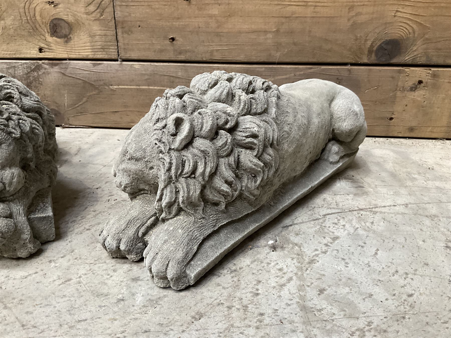 Pair of small cast stone sleeping Trafalgar Lions