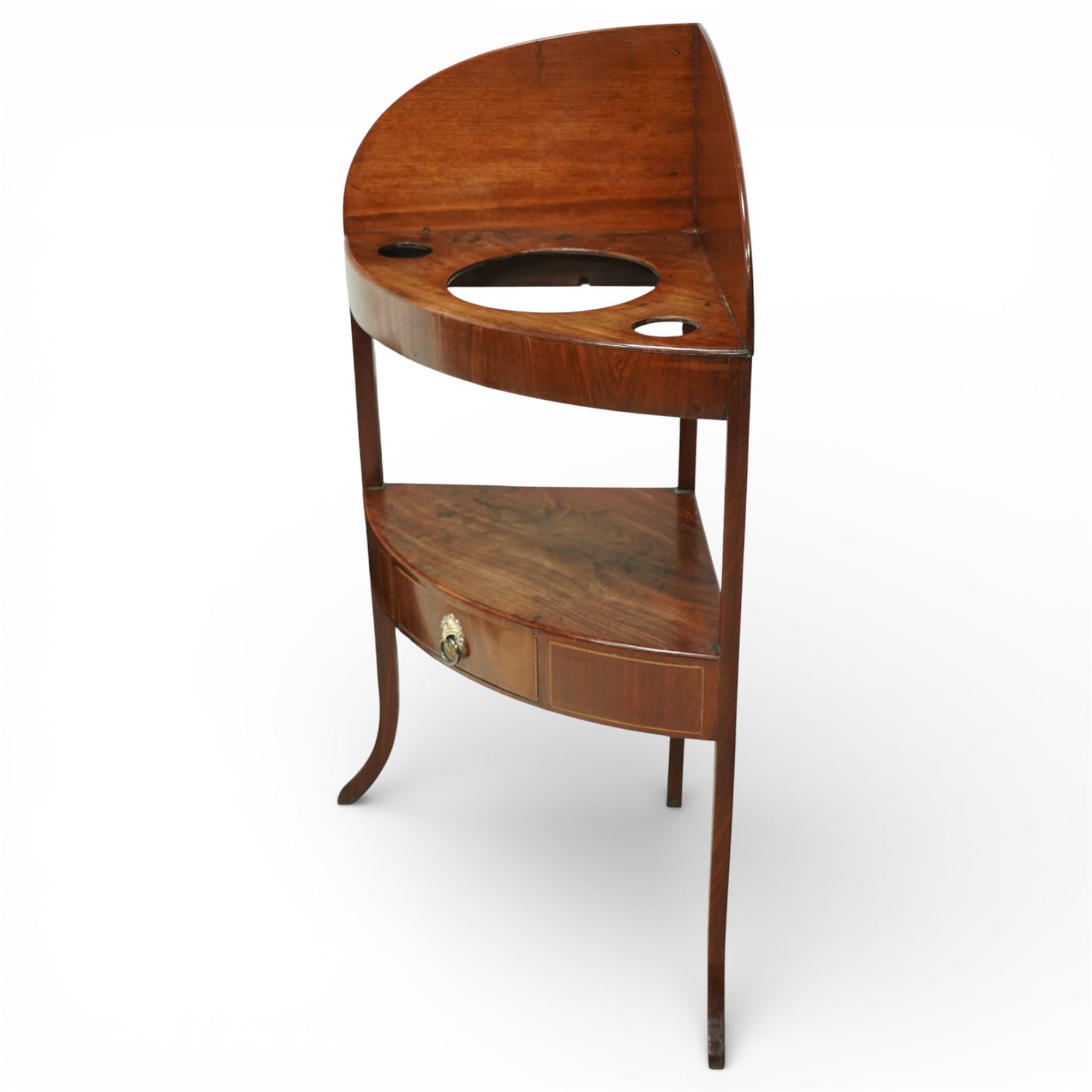 George III mahogany corner washstand, the shaped splash back above a quarter circular top with central basin aperture and flanking soap holes, undertier shelf, single bowed drawer with brass ring handle, raised on slender square and cabriole supports