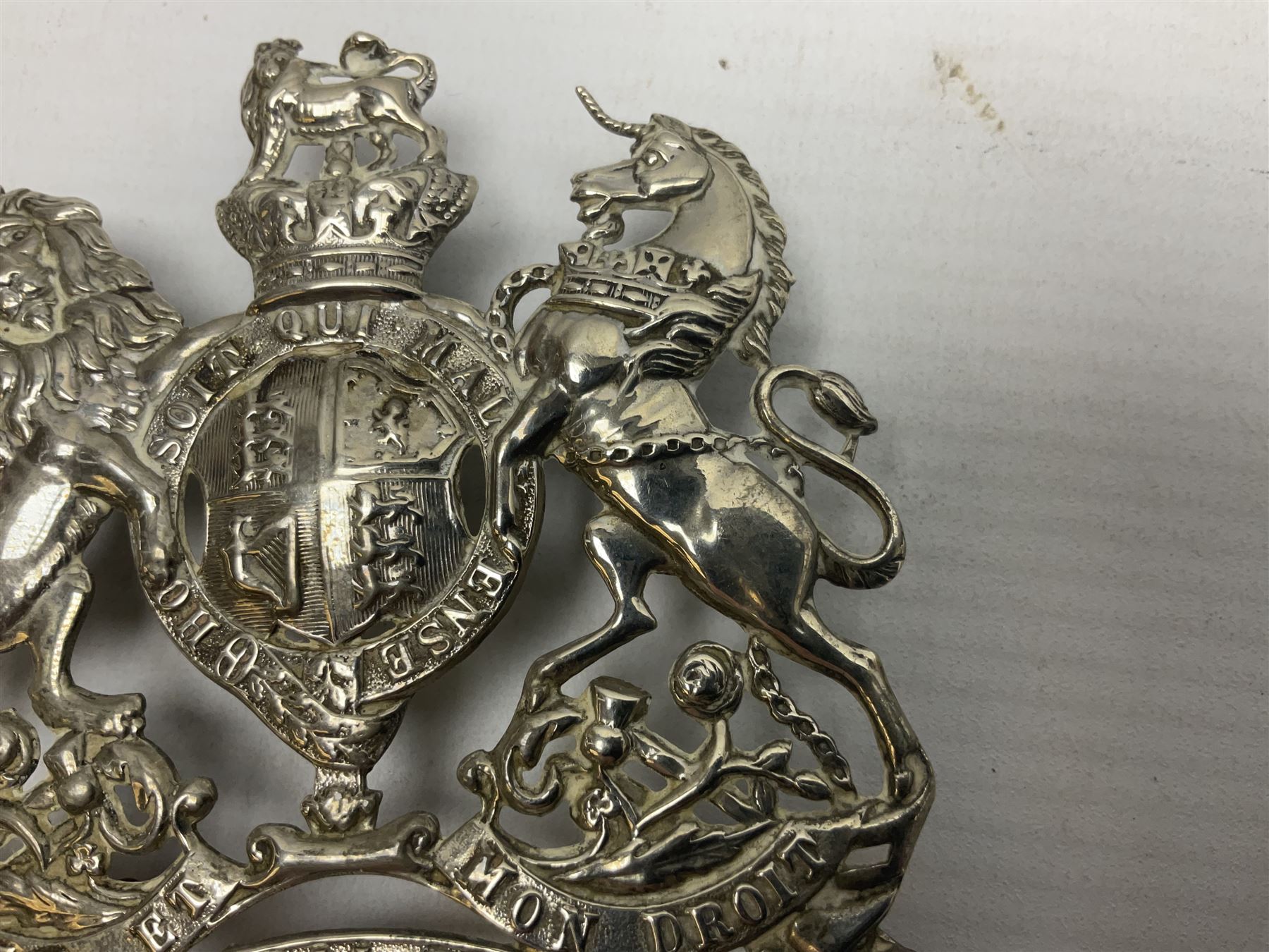 Victorian Volunteer Medical Staff Corps white metal helmet plate in the form of Victorian crowned Royal Arms with three part lower scroll for “VOLUNTEER MEDICAL STAFF CORPS”; three lug fittings to the reverse L8.5cm
