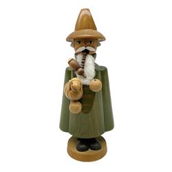German Erzgebirgische Volkskunst folk art carved and stained wood smoking men incense burner figure, modelled smoking a pipe, with sticker label beneath, H19cm