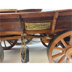 Four Melba Ware Shire horse figures and another similar, and three wood carts