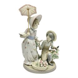  Lladro figure group For You, 5453, modeled as a woman with parasol taking a flower off a kneeling man, H25cm 