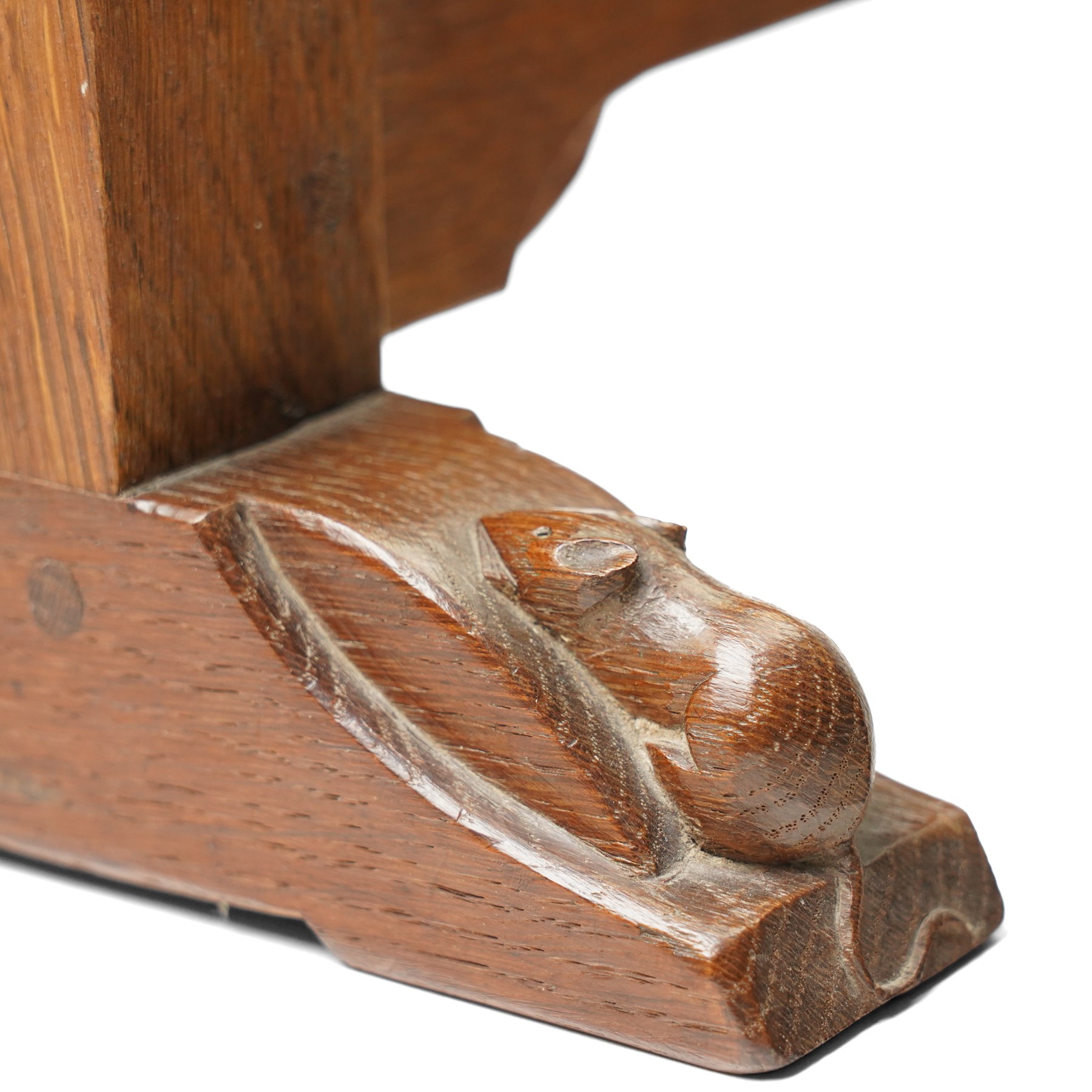 Mouseman - 1930s/40s lightly adzed dark oak dressing table swing mirror, the arcade carved cresting rail over a rectangular plate, the mirror pivots between two lappet-carved turned octagonal supports with dished tops, raised on sledge feet, with carved mouse signature, by the workshop of Robert Thompson of Kilburn