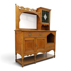 Maple & Co. - Arts & Crafts oak dresser with stained glass cupboard, raised section with pierced pediment above a mirrored back, with a stained glass fronted cupboard with fixed shelf, single long drawer, above a pair of fielded panels, with open recess above a short drawer, raised above a full length undertier with turned supports