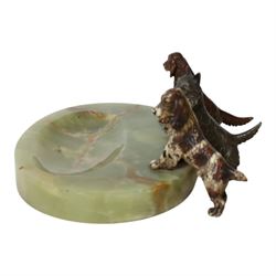 Art Deco ashtray, the oval green onyx tray with oval dished recess, the edge surmounted with three cold painted bronze dogs, comprising Irish Setter, Scottish Terrier and Springer Spaniel, each marked with incised H to base of foot, tray L17cm