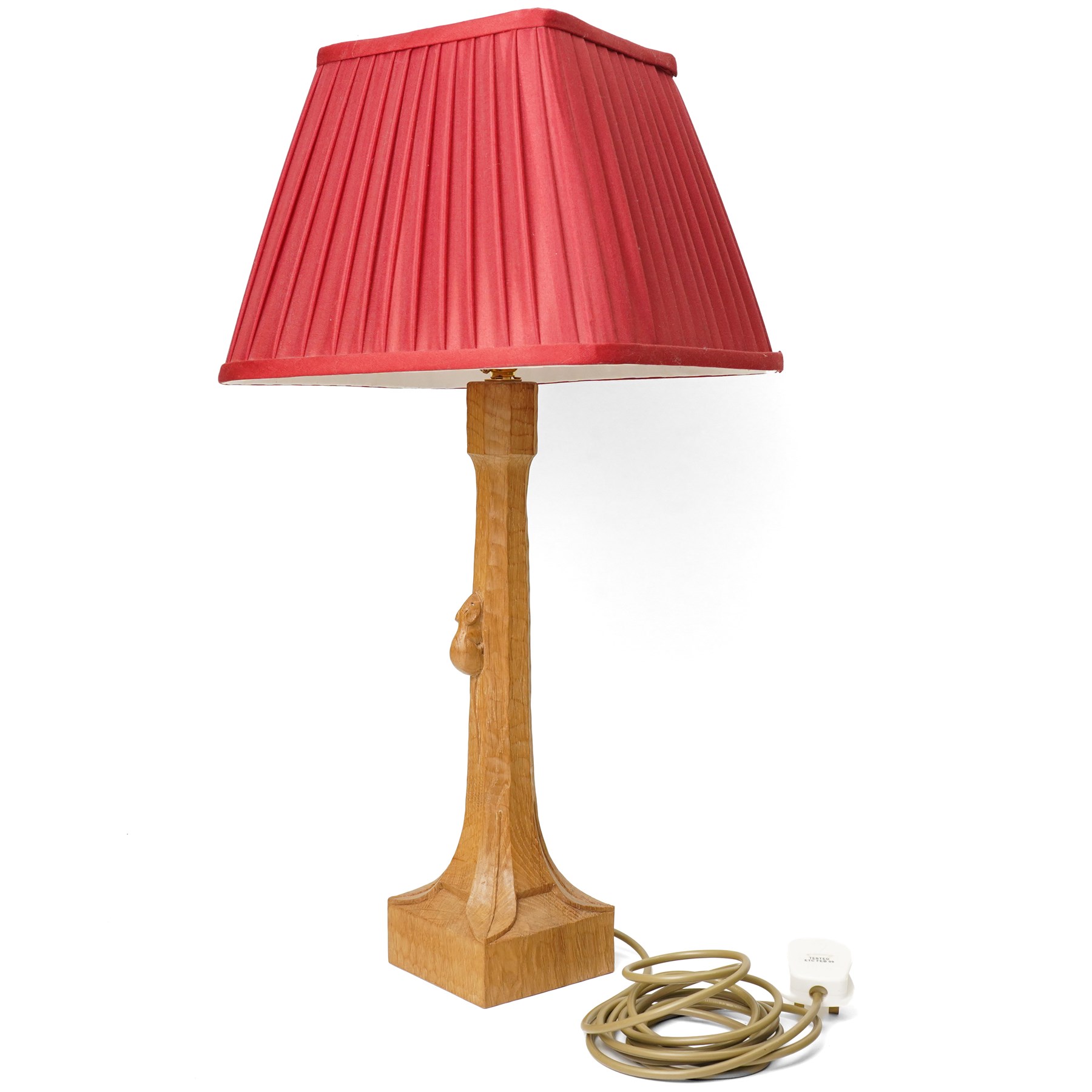 Mouseman - tooled oak table lamp, tapered octagonal stem terminating to square base carved with leaf motifs, with red shade, including shade H60cm, and with carved mouse signature, by the workshop of Robert Thompson of Kilburn