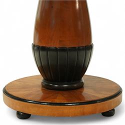 Mid-20th-century Biedermeier-style ebonized and satinwood pedestal table, quarter-veneered circular top with ebonized edge above a tapered baluster quarter-lobed column, raised on a circular plinth base, D87xH70cm, together with two matching upholstered spoon back chairs W45xD47xH87cm