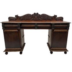 Early 19th century figured mahogany twin pedestal sideboard, fitted with raised back above four frieze drawers, two cupboards with scallop moulding