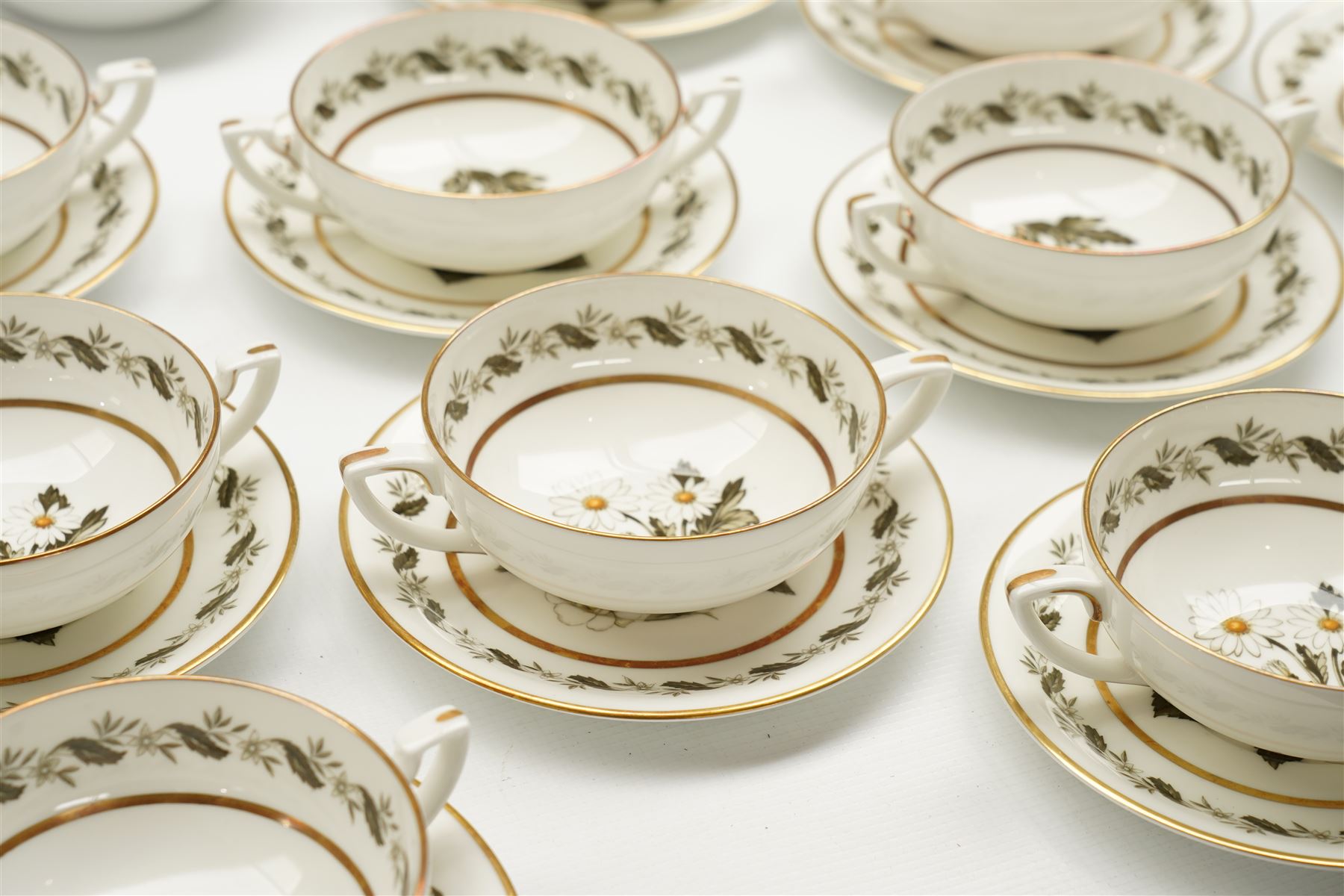 Extensive Royal Worcester Bernina pattern table service comprising thirteen dinner plates, twelve dessert plates, nine two handled soup bowls and stands, twelve side plates, three vegetable dishes and covers, pair of sauce boats and stands, two graduated oval meat plates, eleven tea cups, fourteen saucers, sixteen tea plates, coffee pot and eight coffee cups and saucers, (113 pieces) 