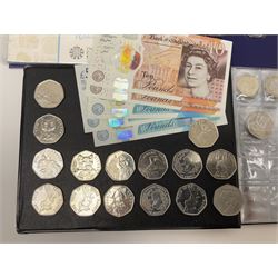 Various The Royal Mint commemorative fifty pence coins, including Beatrix Potter some being housed in folders or displays, other similar commemorative coins, Queen Elizabeth II old style two pound coins etc and five Bank of England Cleland banknotes comprising three five pounds and two ten pounds