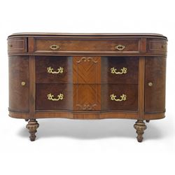 Late 20th century Italian walnut sideboard, serpentine front and bow-shaped top with highly figured veneer, single checkered-pattern frieze drawer over two drawers with central foliage cartouche, flanked by hinged frieze drawers over cupboards, on turned and carved supports