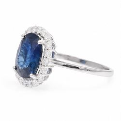 18ct white gold sapphire and diamond cluster ring, single cushion cut sapphire of approx 4.20 carat, surrounded by twenty round brilliant cut diamonds, stamped 750, total diamond weight approx 0.50 carat