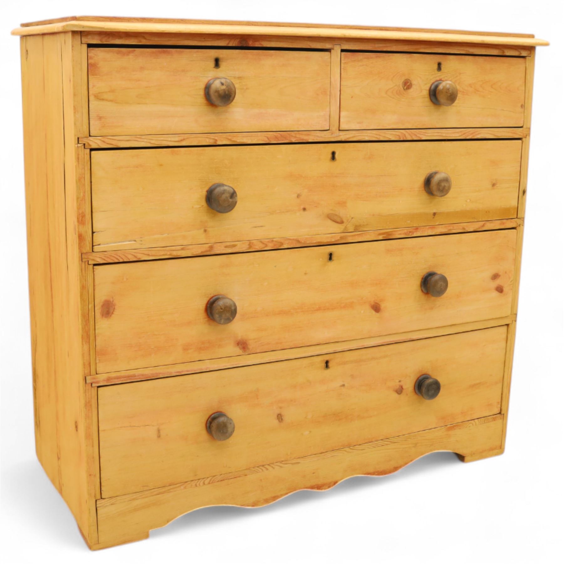 Victorian stripped pine chest, fitted with two short and three long drawers, turned wooden handles, shaped lower apron on bracket feet