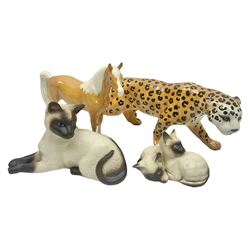 Four Beswick figures, comprising Leopard no 1082, Palomino Arab horse no 1265, Siamese cat no 1558 and Siamese kittens no 1296