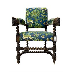 19th century Carolean design oak armchair, upholstered in a vibrant fabric depicting woodland and wildlife scenes, carved lion mask arm terminals, raised on barley twist supports united by H-stretcher
