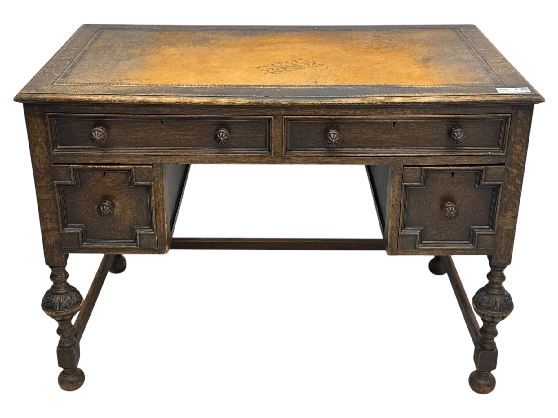 Early 20th century Jacobean design oak desk, with rectangular top inset with worn tooled leather, two frieze drawers over pedestals each fitted with a pair of panelled drawers, turned handles, on carved and fluted tapering legs united by stretchers 