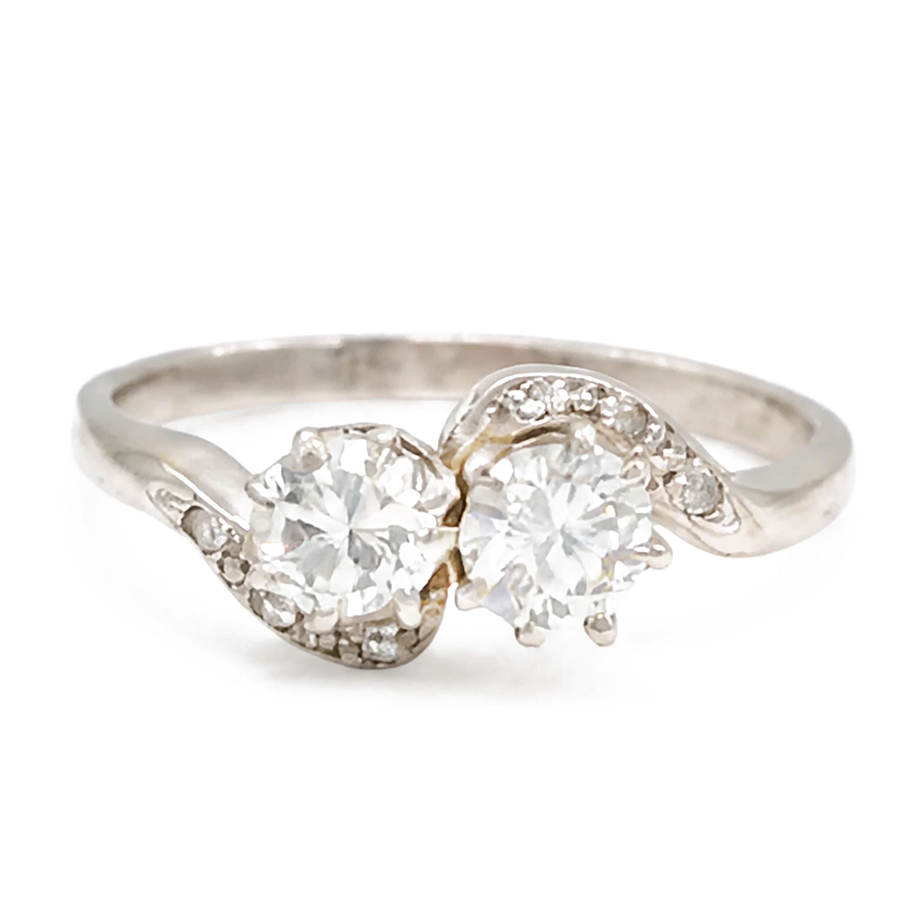 Platinum diamond crossover ring, set with two round brilliant cut diamonds and diamond set shoulders, stamped, total diamond weight approx 0.65 carat