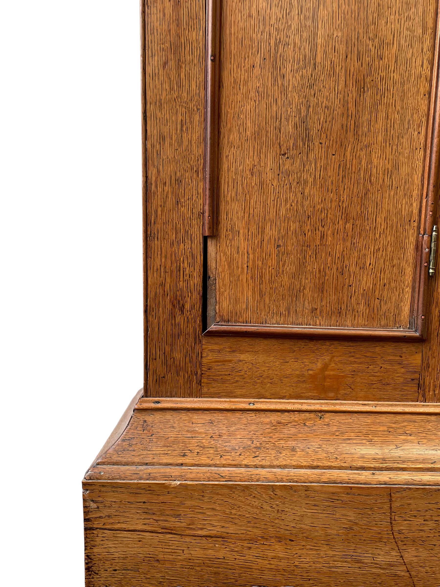 William Gostling of Diss  (Norfolk)-  Late 18th century 8-day oak longcase clock c1780-90, break arch top with scalloped cresting and three brass finials, glazed break arch hood door flanked by turned pilasters with brass capitals, trunk with a long trunk door and rounded top on a square plinth with an applied and shaped skirting, early painted Wilson of Birmingham dial with Roman numerals and five minute Arabic's, matching steel hands and second pointer, arched square ended calendar aperture with date disc behind, floral spandrels within gesso borders and a painted rocking automaton representing Mercury to the break arch, dial pinned via a false plate to a weight driven rack striking movement with a recoil anchor escapement, striking the hours on a cast bell. With pendulum weights and key. 
William Gostling (II) is recorded as working in Diss from 1774 to 1797, succeeded by widow Anne and son George . The dial of this clock is illustrated and discussed in detail in M.F. Tennants book 