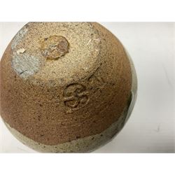 Janet Leach (American, 1918-1997) for Leach Pottery; speckled studio pottery vase of shouldered ovoid form with speckled brown decoration and trailing green and brown glaze upon beige and brown ground, with impressed J.L. monogram and Leach Pottery mark beneath, together with a Jeremy Leach blue speckled lidded circular dish with loop handle, impressed J.L, tallest H11cm