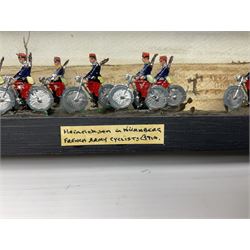 Ten Hinrichsen of Nuremberg flat figures cased French cyclists, with hand painted back drop, paper label to the front marked 'Heinrichson om Hurnburg French Army Cyclists C1914', H10cm, L29cm 