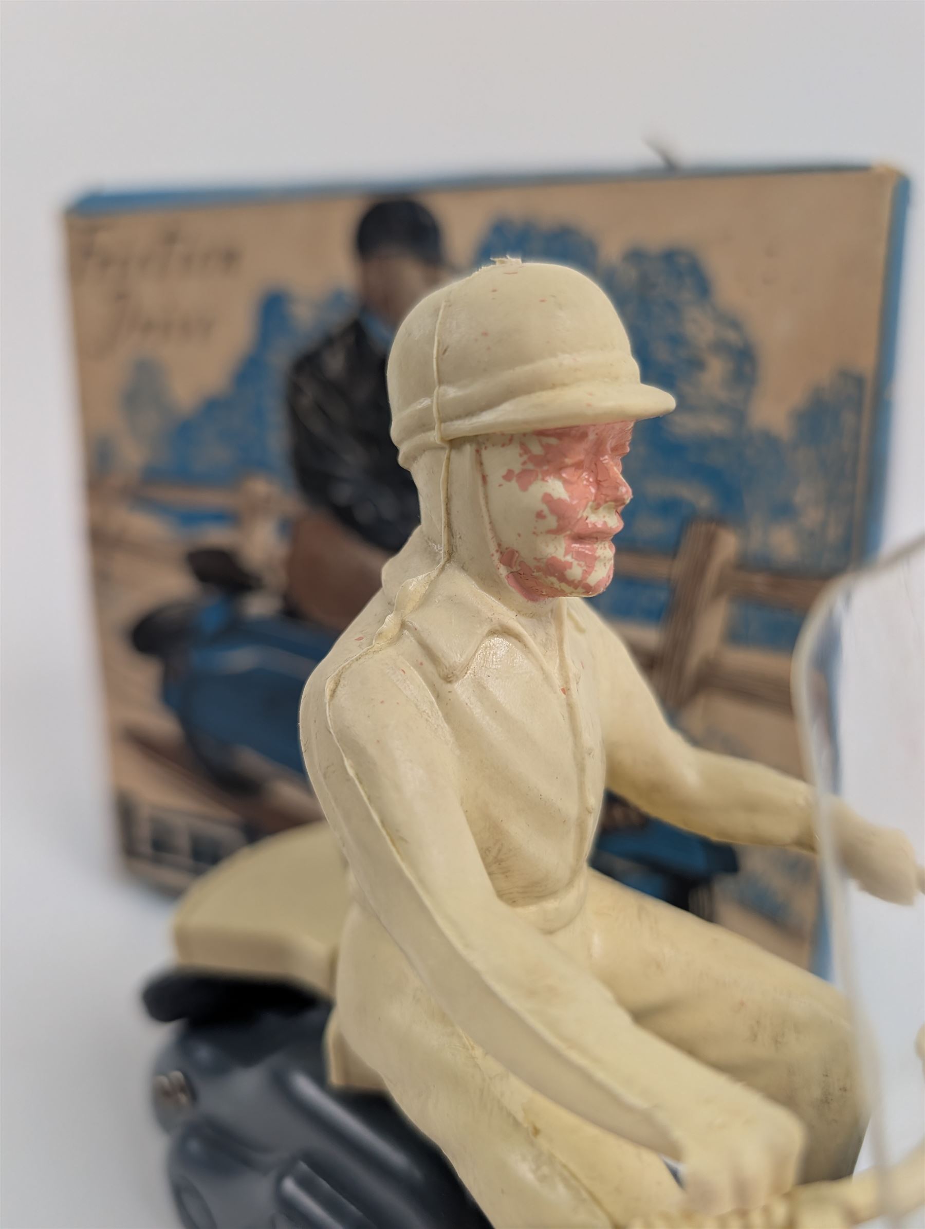 Mettoy friction drive Lambretta scooter no. 8134, the blue plastic scooter with cream handlebars and clear windshield, the rider with cream hat and clothing, stamped MTY 143 to front mud guards, in original box
