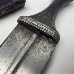 Eastern Jambiya, the 19cm double edge steel blade with raised medial ridge, waisted horn grip with pique work and white metal band; in stitched leather scabbard L33cm overall
