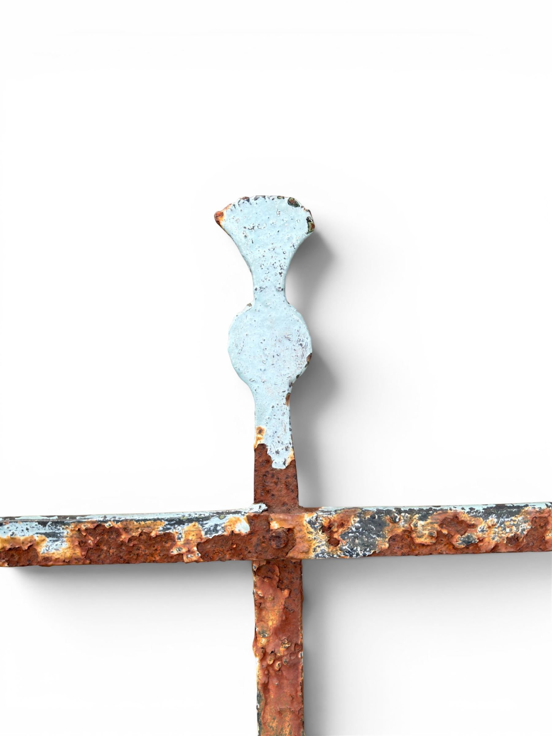 Regency period wrought iron strapwork garden bench, cresting rail with central Scottish thistle motif and flanking pediments, in distressed blue painted finish