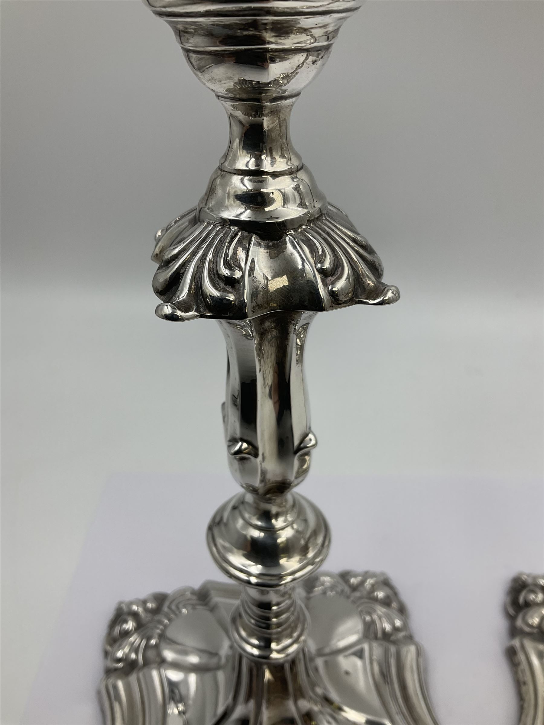 Pair of late Victorian silver mounted candlesticks, each of knopped and part fluted form, upon square stepped base with anthemions to each corner, with conforming sconces, hallmarked to removable sconces and foot, Thomas A Scott, Sheffield 1901, H25.2cm