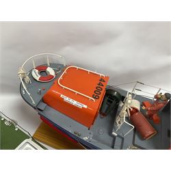 Two remote controlled kit-built plastic model boats - RNLB Sheerness Lifeboat Helen Turnbull L92cm and 'Conserver' Grangemouth L76cm; each on wooden stand; together with three remote control units