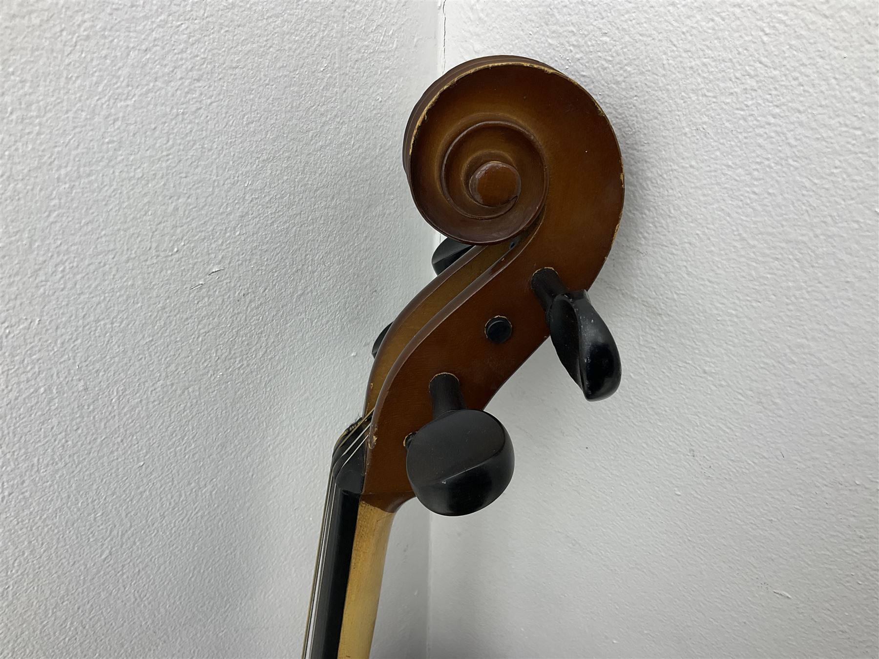 Modern Romanian student's three-quarter size cello with 70cm two-piece maple back and ribs and spruce top, bears label 'Musikinstrumentenfabrik Reghin Romania' L115cm overall