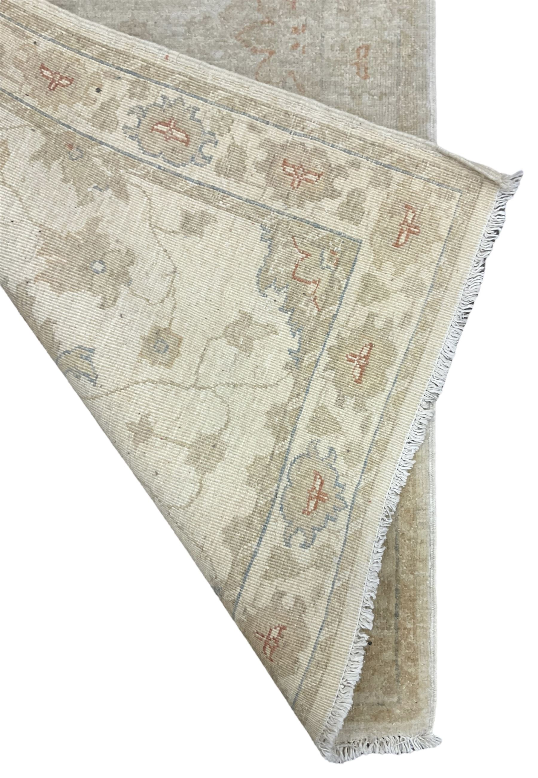 Persian Zeigler runner, ivory ground decorated with faint floral design 