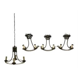 Gothic style iron chandelier with drip pans and twisted branches together with three matching twin wall sconces