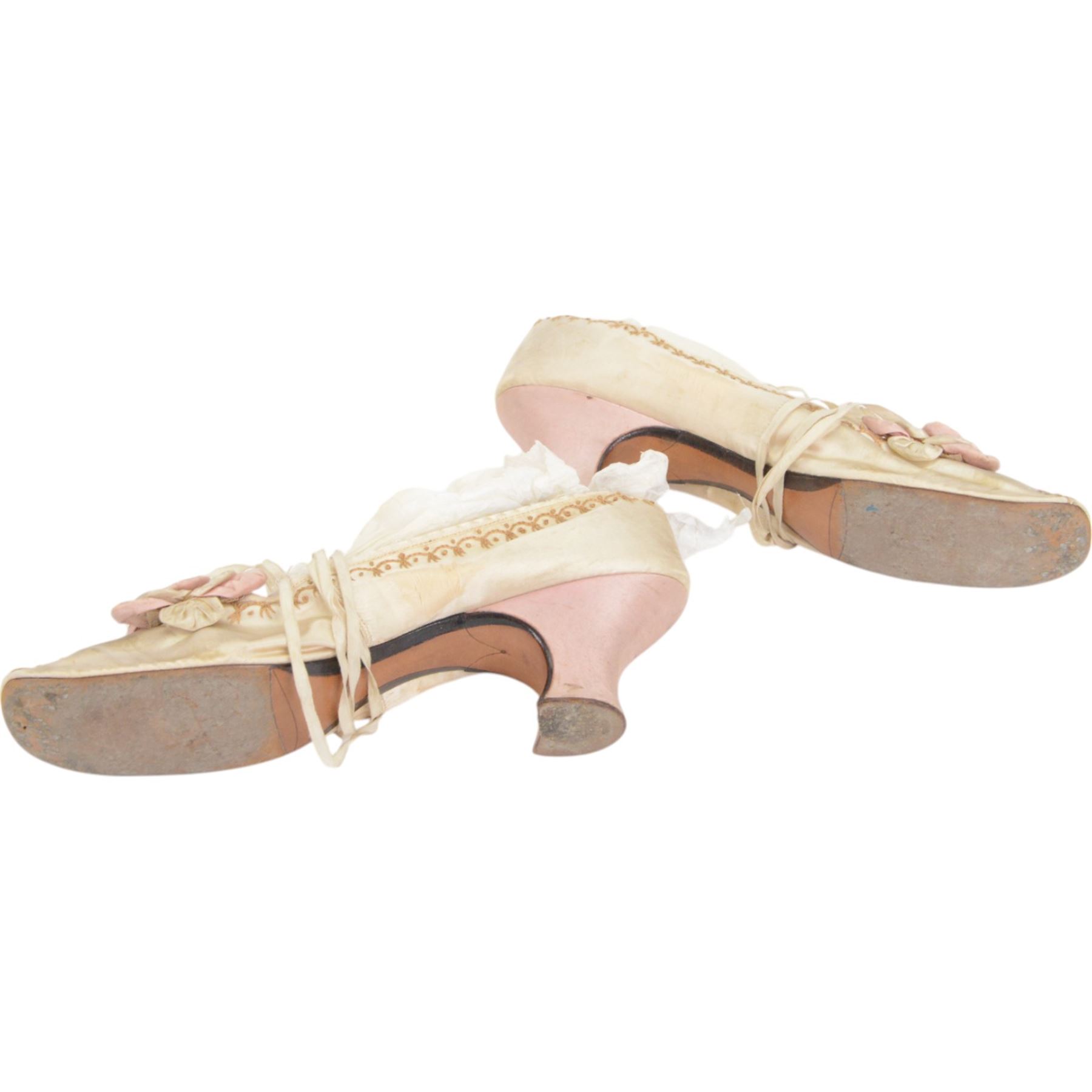 Pair of 19th century ivory silk satin ladies shoes, with rosette to the vamp, with pink silk satin heel, L23cm