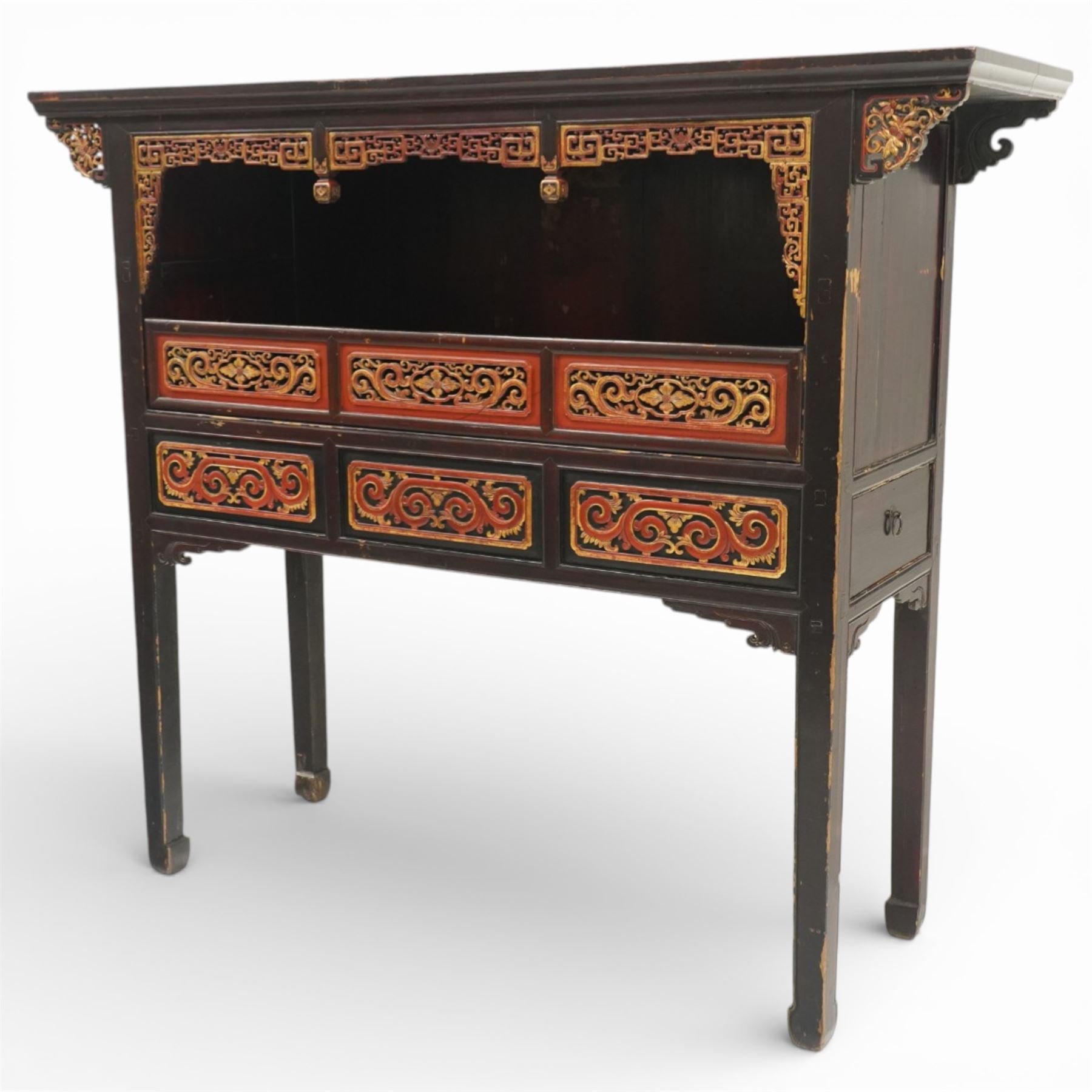 Chinese black lacquer Buddha cabinet, moulded top over open display recess framed by pierced geometric fretwork and corner spandrels, the base fitted with an arrangement of five drawers with carved and gilt scrollwork panels, on square supports with shaped apron brackets