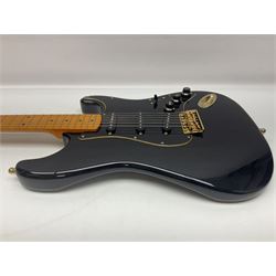 Copy of a Fender Stratocaster electric guitar in black with Wilkinson bridge, lock-in tuners, synchronised tremolo and various patent numbers; L99cm; in hard carrying case with strap and digital tuner